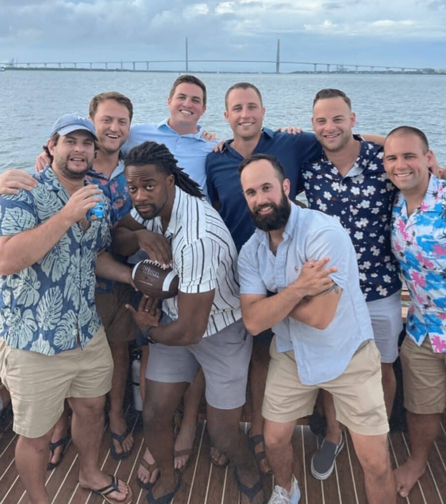 Excited passengers cheering on the Friki Tiki party boat during a Charleston harbor cruise.