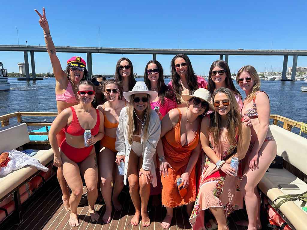 Top Boat Party Amenities and Comfort in Charleston Passengers enjoying the top boat party amenities and comfort on the Friki Tiki, featuring shaded lounge seating and a spacious deck in Charleston, SC.