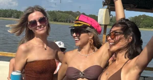 Charleston bachelorette party on a boat with friends enjoying drinks and sunshine on the water