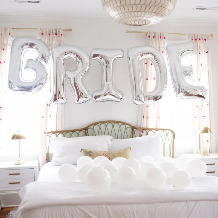 kay-and-co-bachelorette-decor-charleston Charleston bachelorette party bedroom setup with bride balloons and decorations
