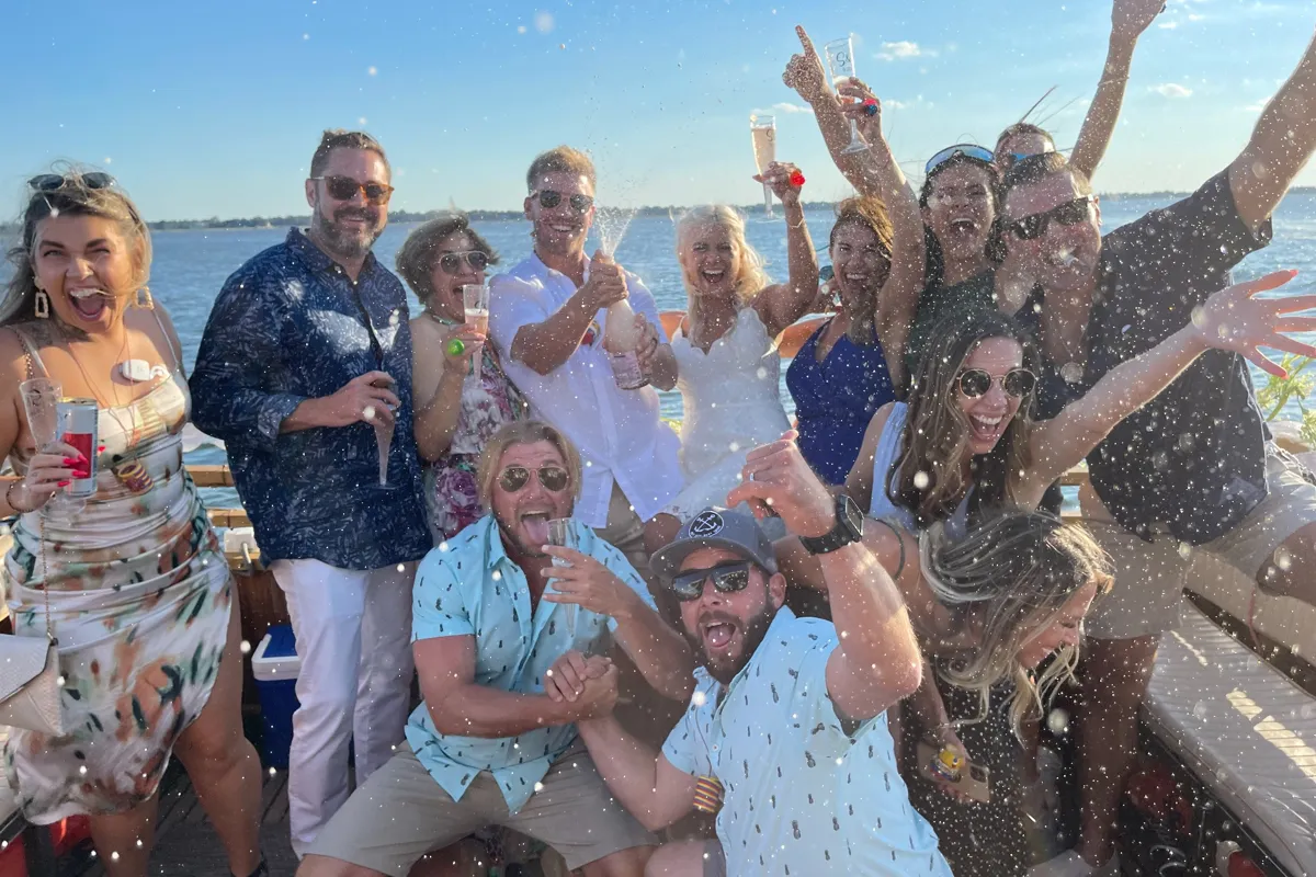 Charleston boat wedding on the Friki Tiki with bride and groom celebrating on the water