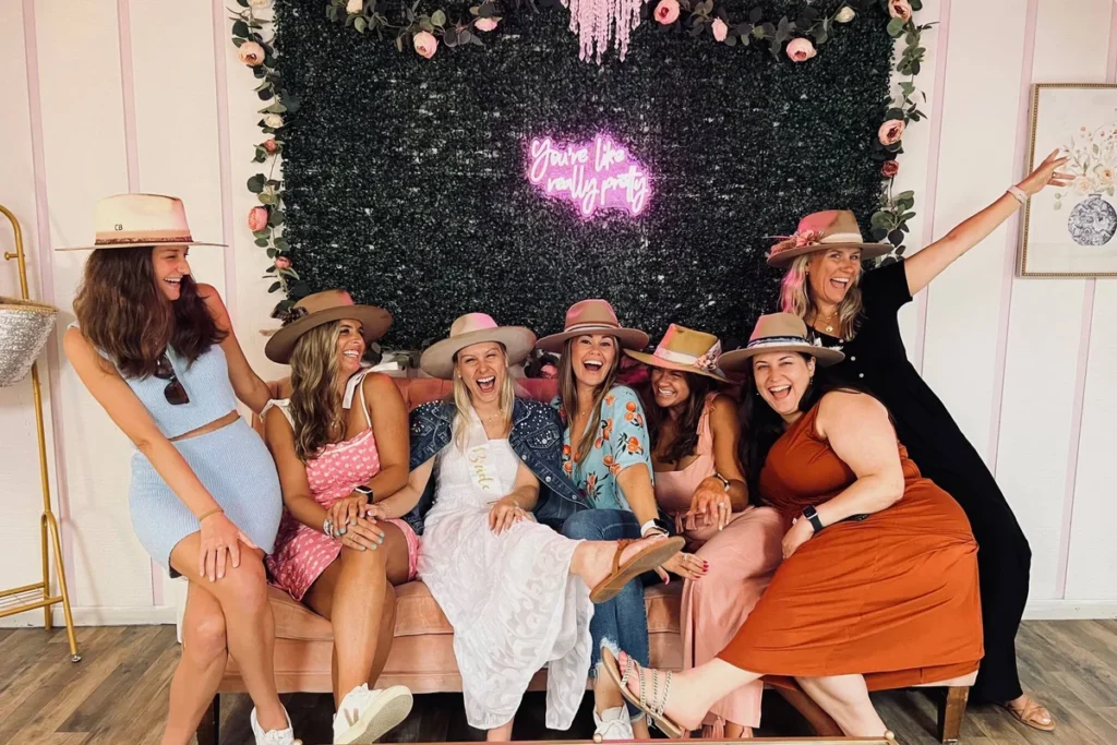 southern-rutz-custom-hats-charleston-bachelorette Charleston bachelorette party group wearing custom hats from Southern Rutz during a group activity
